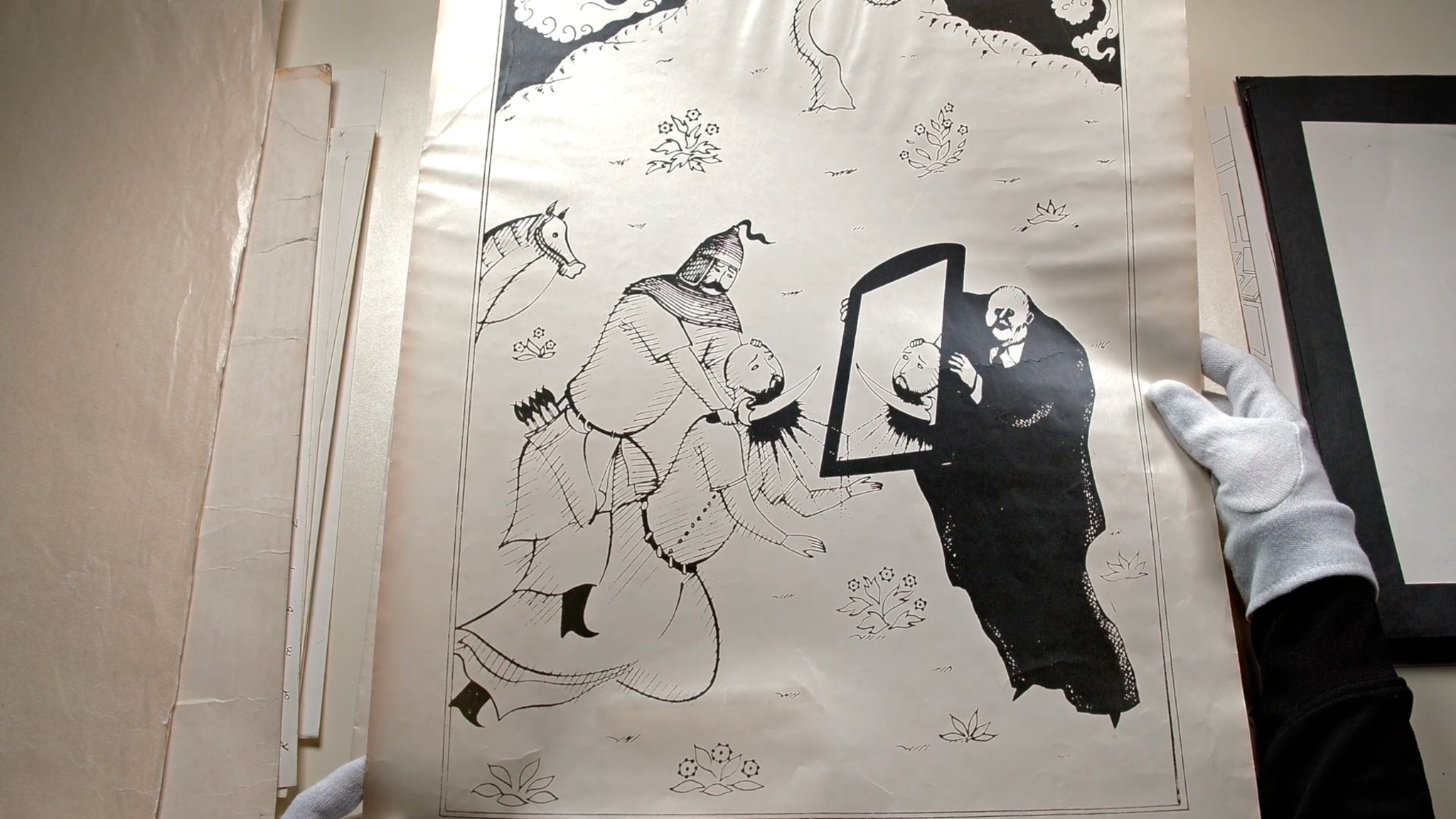 Film still showing a Kambiz Derambakhsh drawing and archival material